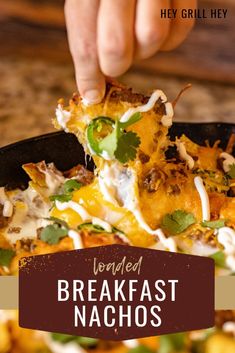 someone is taking a piece of food out of a skillet with the words world's best breakfast nachos on it