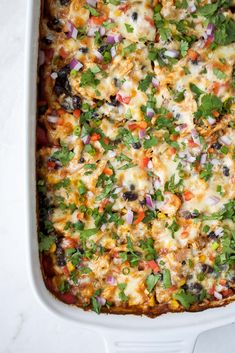 a casserole dish filled with vegetables and cheese