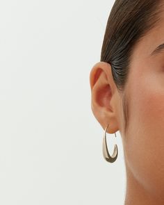 These exquisite pull-through teardrop earrings, measuring 24mm x 18mm with a 9mm opening, add an elegant touch to any look. Their distinctive shape and ideal size offer both style and comfort. Suited for any occasion, they enhance casual wear and elegantly complement dressy events, adding a touch of luxury at a great value. Materials 14K yellow gold or white gold plated. s925 Sterling Silver Posts. Measurements: Length: 24mm x 18mm; Opening: 9mm. Hypoallergenic; nickel, lead, and cadmium free. Pull Through, Teardrop Earrings, Casual Wear, Gold Plate, White Gold, Yellow Gold, Drop Earrings, Sterling Silver, Yellow