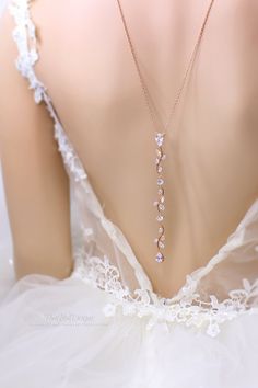 A simple but elegant silver backdrop necklace with zircon connector in the front and a lovely teardrop cubic zircon drop at the back. It is perfect for a backless or low back dress. This elegant design can be used to dress up a backless dress or even as a bridal necklace, bridesmaids necklace or wedding gift. Necklace~ Weight: 13g Finish: Rose gold plated or Rhodium silver plated components Material: AAA Zirconia, 14K Silver Platinum chain or 14K Rose gold plated chain. Length of necklace is 26 Rose Gold Drop Necklace For Wedding, Rose Gold Wedding Necklace With Elegant Design, Rose Gold Clavicle Chain Necklace For Wedding, Gold Cubic Zirconia Backdrop Necklace As Gift, Gold Cubic Zirconia Backdrop Necklace For Gifts, Gold Cubic Zirconia Jewelry For Bride, Gold Dangle Drop Necklace For Wedding, Wedding Rose Gold Dangle Necklaces, Delicate Gold Bridal Necklace For Bridal Shower