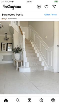 an instagram page with stairs and potted plants on the bottom floor, in front of a white staircase