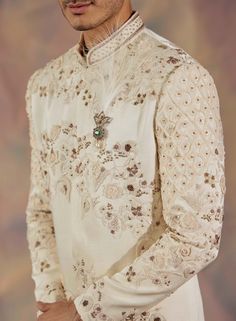 Editor's Note Featuring Dirty Ivory Hand Embroidered Sherwani With All Over Tone-on-tone Applique Flowers. Paired With Chikankari Dupatta, Matching Pintuck Kurta And Churidar Fabric: Linen Silk Color: Ivory Component: Sherwani, Kurta, Churidar, Stole Care: Dry Clean Only About the Designer After establishing himself as the leading couturier in the industry of menswear, Jatin Malik went on to explore luxury footwear. You can order online these amazingly designed handmade shoes that are being offe Jatin Malik, Embroidered Sherwani, Blouse Yoke, Applique Flowers, Indian Wedding Outfits, Kurta Designs, Churidar, Bridal Jewelry Sets, Floral Motifs