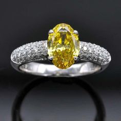 For Sale on 1stDibs - A very fine diamond engagement ring. Set in its center an oval fancy vivid yellow diamond weighing 1.36 cts. Its rich color is the most desirable : vivid White Gold Engagement Ring, Diamond Engagement Ring Set, White Gold Engagement, Engagement Ring Set, White Gold Engagement Rings, Yellow Diamond, Gold Engagement Rings, Diamond Engagement Ring, Diamond White