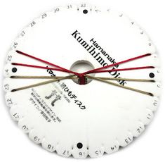 a white clock with red hands and numbers on the face is shown in front of a white background