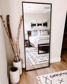 a large mirror sitting on top of a wooden floor