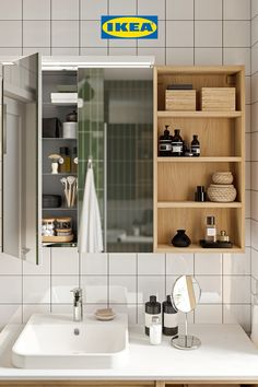 a bathroom with a sink, mirror and shelves on the wall next to each other