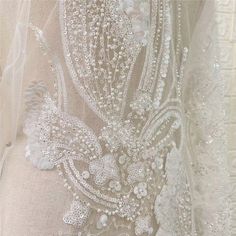 the back of a wedding dress with beading on it