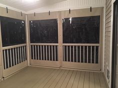 an empty room with sliding doors and wood flooring on the side of the building