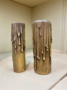 two vases sitting on top of a white table