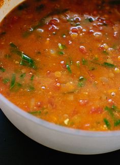 a white bowl filled with soup on top of a table