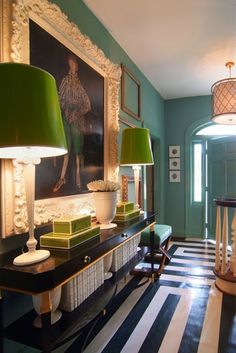 the room is decorated with green lamps and pictures on the wall, along with black and white checkered flooring