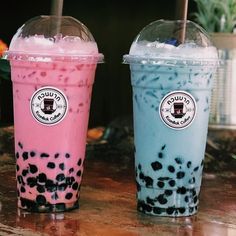 two bubble teas are sitting next to each other