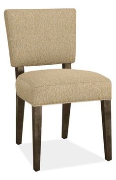 an upholstered chair with wooden legs and a beige fabric seat pad on the back