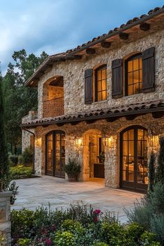 a large stone house with lots of windows