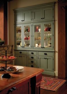 an old fashioned china cabinet with glass doors