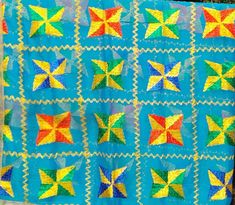 a blue quilt with multicolored stars on it