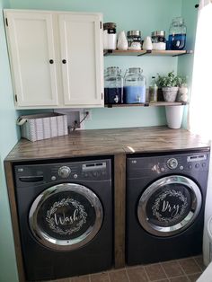 the washer and dryer are sitting side by side in the laundry room next to each other