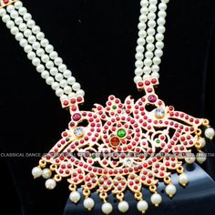 Original Design by Classical Dance Jewelry® ❥ Pearl Kempu Long Haram Chain is traditional and ethnic South Asian Indian Jewelry. ❥ 4 lines Open Peacock Style Pendant Pearls Long Necklace. ❥ You Can wear this set for Bharatnatyam Kuchipudi Dance Performances, Engagement, Weddings, Birthdays, festivals, puja, Ammavaru Amman decorations, Durgamata Decoration ❥ Handmade Indian Traditional Item. ❥❥❥ Set has variations please CHECKOUT Variants ☛ Long Necklace with earrings ☛ Long Necklace without earr Bollywood Style Temple Necklace With Peacock Design For Diwali, Bollywood Temple Necklace With Peacock Design For Diwali, Traditional Kundan Necklace With Peacock Design For Wedding, Traditional Temple Necklace With Peacock Design For Navratri, Navratri Ceremonial Temple Necklace With Peacock Design, Ceremonial Temple Necklace With Peacock Design For Navratri, Diwali Temple Necklace With Peacock Design For Puja, Diwali Puja Temple Necklace With Peacock Design, Traditional White Temple Necklace For Festive Occasions