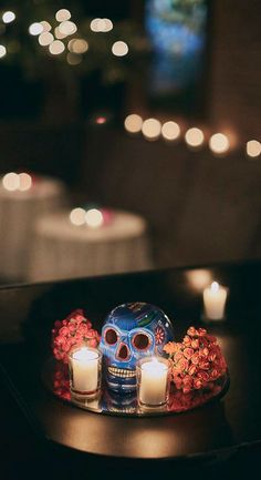 a table with candles and a blue skull on it