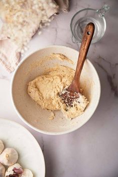 a wooden spoon in a bowl filled with food