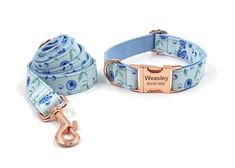 a blue and white floral dog leash with a rose gold name tag attached to it