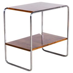 a wooden table with metal legs and a wood shelf on the bottom that has two shelves underneath it