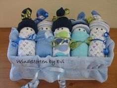 a baby boy gift basket filled with blue and white stuffed animals in it's wrappers