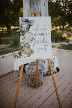 a sign that says welcome to charlie's birthday party with an elephant and giraffe on it