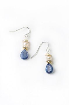 Elegant pearls with rich blue kyanite create both a dressy and laid back pair of handmade dangle silver and pearl earrings for women! Simple pearls with kyanite briolette drop are fun for everyday wear. Sterling silver Freshwater pearl, kyanite Approx 1.5" length Our unique handcrafted designer jewelry for women is made in America, each design created individually in our personal design studio in Floyd VA USA Simple Gemstone Earrings, Handmade Drop Earrings, Everyday Jewelry Simple, Diy Earrings Dangle, Floyd Va, Dangle Silver Earrings, Handmade Pearl Jewelry, Dark Blue Earrings, Jewelry Materials