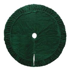 a green round cushion with ruffled edges