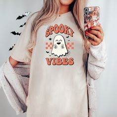 This retro Spooky Season Halloween Comfort Colors Tee is perfect for the upcoming Halloween season. This shirt puts a trendy twist on the spooky season.  Spooky Vibes Retro Halloween Shirt, Women's Comfort Colors Tee, Oversized Cozy T-Shirt, Women's Halloween T-Shirt, Neutral Halloween Shirt T-Shirt Description Comfort Colors is back with its garment-dyed t-shirt, a fully customizable tee made 100% with ring-spun cotton. The soft-washed, garment-dyed fabric brings extra coziness to your wardrobe Oversized White T-shirt For Halloween, Neutral Halloween, Spooky Vibes, Comfort Colors Tee, Retro Halloween, Halloween T Shirt, Halloween Season, Halloween Women, Dyed Fabric