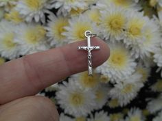 "Tiny Crucifix Charm Small crucifix cross with an antique silver finish. The small size makes them perfect for dainty necklaces, charm bracelets, or small rosary chaplets. Size: 22mm long x 11.11mm wide (7/8\" long x 7/16\"wide) Made from a zinc-based alloy which is lead, nickel, cadmium safe." Nickel-free Silver Cross Rosary Bracelet, Silver Cross Rosary As Gift, Silver Cross Rosary Bracelet, Nickel-free Silver Cross Rosary, Small Rosary, Rosary Cross, Crucifix Necklace, Dainty Necklaces, Bracelet Charms