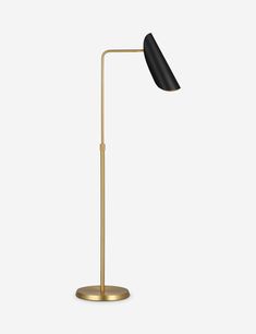 a black and gold floor lamp on a white background, with the light turned off