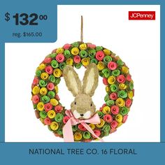 a christmas ornament with a bunny in the center and flowers on it's front