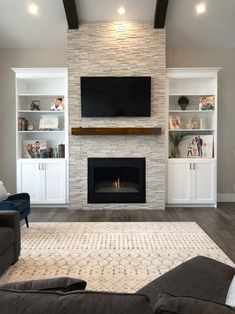 a living room with a fireplace and entertainment center