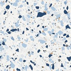 an abstract blue and white background with speckles in shades of gray, beige, and black