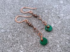 These dainty malachite drop pendant earrings feature a single malachite gemstone pendant wrapped in high-quality pure copper.  Flaunt this modern, sophisticated look with a minimalist deco feel to compliment your style and elevate any outfit. These earrings are part of the Mangrove collection, inspired by the mangrove marshes of South Florida, with copper elements evoking the branching exposed roots and deep green gemstone and beads evoking lush plant life that is beautifully cohesive and unique in the world. Shop the collection here: https://www.etsy.com/shop/TheSubtleParts?ref=dashboard-header&section_id=50053555 Give as a memorable unique gift to the favorite woman in your life:  For Mother's Day, anniversary presents, Christmas gifts, birthday gifts, graduation and bachelorette parties Bronze Wire Wrapped Drop Earrings, Copper Dangle Jewelry As Gift, Copper Dangle Jewelry For Gift, Artisan Copper Wire Drop Earrings, Copper Wire Drop Earrings With Matching Set, Handmade Copper Drop Earrings, Elegant Copper Wire Pendant Jewelry, Artisan Copper Wire Dangle Jewelry, Minimalist Copper Jewelry As Gift