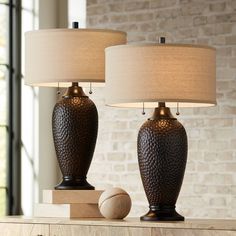 two lamps sitting on top of a wooden table