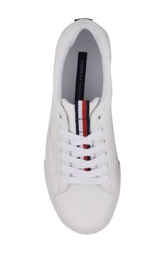 Step into a classic sneaker that has a clean style with Hilfiger's signature red, white and navy stripes on the tongue and a cool perforated 'H' on the side. Lace-up closure Synthetic upper/textile lining/rubber sole Imported Women's Shoes Classic Skate Shoes With Perforations And White Sole, Classic Low-top Skate Shoes With Perforations, Tommy Hilfiger Lace-up Sneakers With Embossed Logo, Classic Lace-up Skate Shoes With Embossed Logo, White Casual Skate Shoes With Embossed Logo, Sporty Tommy Hilfiger Sneakers With Embossed Logo, Tommy Hilfiger Sporty Sneakers With Embossed Logo, White Leather Tommy Hilfiger Sneakers, Classic Tommy Hilfiger Leather Sneakers