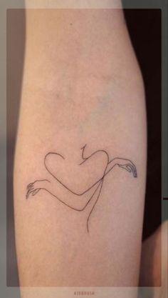 a woman's leg with a tattoo on it that is shaped like a heart