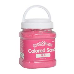 a jar of pink colored sand on a white background