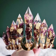 "𝕻𝖊𝖗𝖘𝖊𝖕𝖍𝖔𝖓𝖊 is an entrancing crown created using our crystal resin forms that have been carefully filled with faux gold flake and real dried violet flowers. Hand wire wrapped garnets as rich as ripe pomegranate seeds surround the entire setting. Finished with a golden double horn crescent moon centerpiece.  Can be made as a traditional crown style as well! It's always your choice, goddess.  - Epoxy resin crystal forms - Real dried violet flowers - faux gold flake - Rich red garnet gems Mystical Festival Crown Headpiece, Bohemian Teardrop Crown For Festivals, Bohemian Tall Crown For Party, Unique Handmade Crown Headpiece, Mystical Crown Headpiece For Wedding, Fantasy Crown Jewelry For Party, Handmade Fantasy Headpiece With Tall Crown, Bohemian Crown For Festival With Structured Shape, Unique Wedding Crown Headpiece