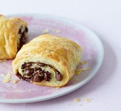 two pastries on a pink and white plate