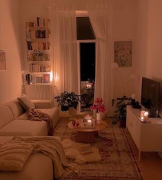 a living room filled with furniture and candles