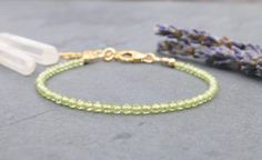 Dazzling, faceted green Peridot beads create a minimalist yet sophisticated piece of gemstone jewelry. This bracelet is delicate yet made for everyday wear.  This simple and dainty beaded gemstone bracelet features a light shade of green and is the perfect gift for an August birthday. .: G E M S T O Elegant Lime Green Beaded Jewelry, Green Dainty Jewelry With Faceted Beads, Adjustable Elegant Lime Green Jewelry, Elegant Peridot Round Beads Jewelry, Peridot Faceted Beads Jewelry Gift, Elegant Lime Green Jewelry With Round Beads, Minimalist Green Beaded Bracelets With Natural Stones, Minimalist Green Faceted Jewelry, Faceted Green Beaded Bracelets As Gift