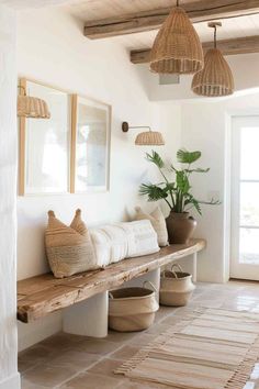 a wooden bench sitting next to a window in a living room with potted plants