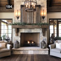 a living room filled with furniture and a fire place under a chandelier over a fireplace