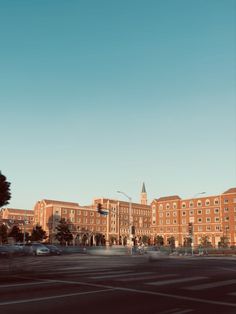 an empty parking lot in front of a large building