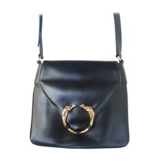 GUCCI Extremely rare ebony leather equestrian emblem handbag c 1970s Luxurious smooth black leather shoulder bag with sleek gilt metal hardware. The rare Gucci handbag is adorned with twin gilt metal horse heads labeled the ribbot handbag by Gucci . The interior is lined in black leather Stamped in gilt script lettering : Made in Italy by Gucci On Sale Reduced from $1500 dollars Navy Blue Bag, Gucci Vintage Bag, Horse Heads, Metal Horse, Gucci Handbag, Colorful Handbags, Black Leather Shoulder Bag, Equestrian Boots, Perfect Handbag