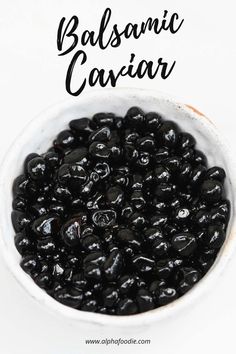 a white bowl filled with black olives and the words balsamic caviar